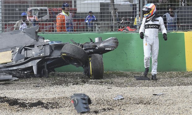 Fernando Alonso looks at his McLaren after the crash during the Formula One Australian Grand Prix. AP