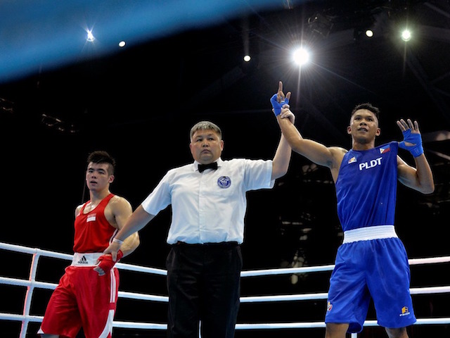 Philippines' Eumir Felix Marcial, right, celebrates winning the fight against Singapore's Tay Jia Wei. Singapore SEA Games Organising Committee / Action Images via Reuters