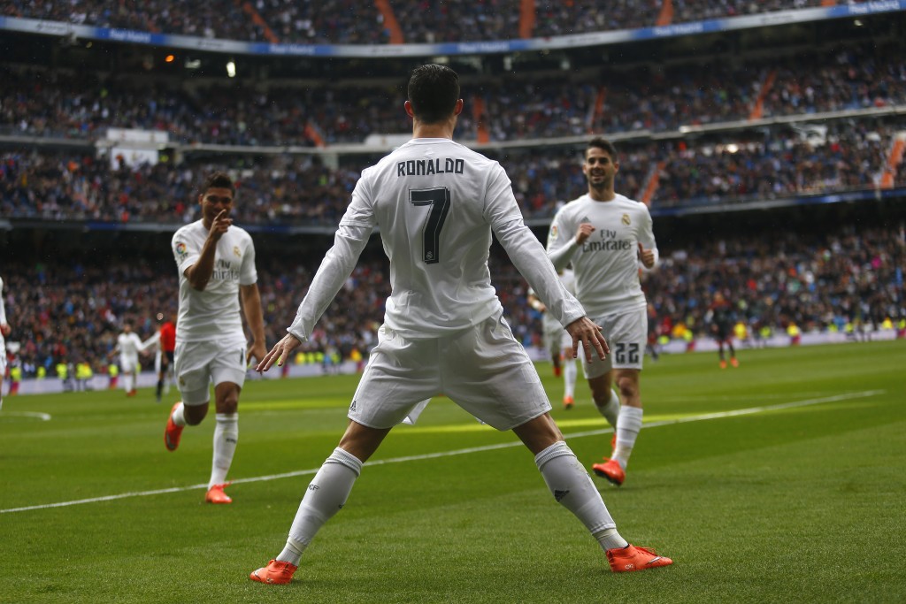 Real Madrid's Cristiano Ronaldo celebrates with teammates after scoring a goal against Celta during a Spanish La Liga soccer match between Real Madrid and Celta Vigo at the Santiago Bernabeu stadium in Madrid, Saturday, March 5, 2016. Ronaldo scored four goals in Real Madrid's 7-1 victory.  (AP Photo/Francisco Seco)