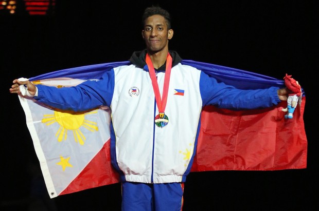 Gold medalist Samuel Thomas Morrison of the Philippines during the awarding ceremony of the 28th SEA Games mens under 68kg final held at the Singapore Expo Hall 2 after defeating Trung Duc Phan of Vietnam. INQUIRER PHOTO/RAFFY LERMA 