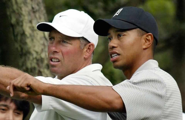 Tiger Woods (R) checks the course with his caddie, Steve Williams, during his round in Pro-Am Charity Golf in the Dunlop Phoenix tournament in Miyazaki, in 2002. AFP