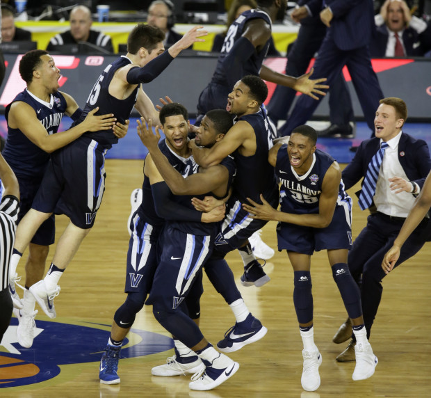 Villanova players celebrates after Kris Jenkins, center, scores a game winning three point basket in the closing seconds of NCAA Final Four tournament college basketball championship game Monday, April 4, 2016, in Houston. Villanova won 77-74. (AP Photo/Charlie Neibergall)