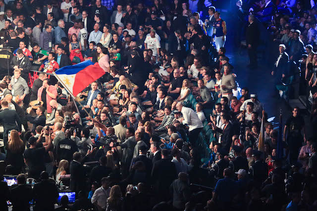 A Philippine flag is being waved inside the MGM Grand Garden Arena in Las Vegas during the third fight between Manny Pacquiao and Timothy Bradley. Pacquiao won by unanimous decision. PHOTO BY REM ZAMORA