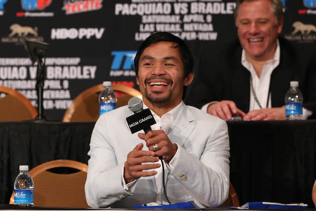 A beaming Manny Pacquiao shows up at the post-fight press conference at the MGM Grand Garden Arena in Las Vegas. PHOTO BY REM ZAMORA