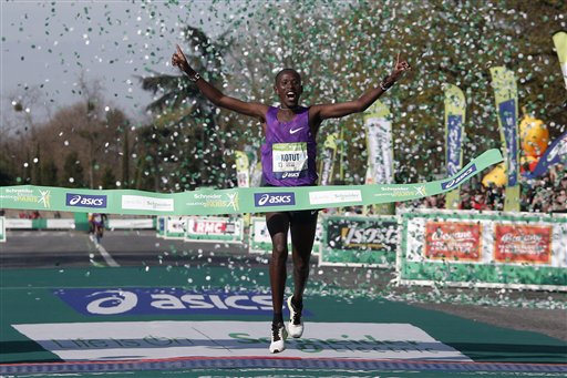 Cyprian Kotut of Kenya crosses the finish line to win the 40th Paris Marathon men's race, as Kenyan runners pulled off a podium sweep in perfect weather conditions. AP