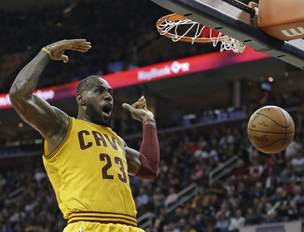Cleveland Cavaliers' LeBron James reacts after dunking the ball against the Brooklyn Nets in the first half of an NBA basketball game Thursday, March 31, 2016, in Cleveland. (AP Photo/Tony Dejak)