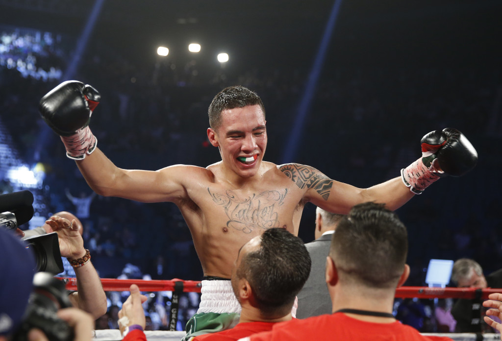 Oscar Valdez, of Mexico, celebrates after defeating Evgeny Gradovich, of Russia, in the fourth round of their featherweight title boxing bout Saturday, April 9, 2016, in Las Vegas. (AP Photo/Isaac Brekken)
