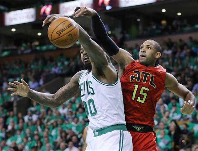 Atlanta Hawks center Al Horford knocks a rebound away from Boston Celtics forward Amir Johnson during the first half in Game 6 of a first-round NBA basketball playoff series Thursday, April 28, 2016, in Boston. Curtis Compton/Atlanta Journal-Constitution via AP