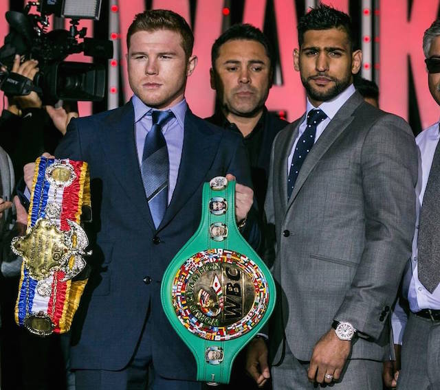 Caption: Canelo Alvarez, left, and Amir Khan, right, pose for a photo with promoter Oscar De La Hoya, center, in Los Angeles on Wednesday, March 2, 2016. The boxers are scheduled to fight on May 7 in Las Vegas for Alvarez's WBC middleweight title. AP