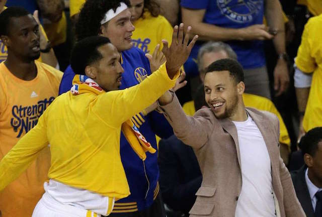 Golden State Warriors' Stephen Curry, right, and Shaun Livingston celebrate a score against the Houston Rockets from the bench during the first half in Game 5 of a first-round NBA basketball playoff series Wednesday, April 27, 2016, in Oakland, Calif. AP
