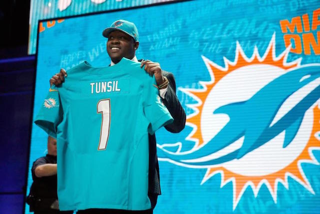 Mississippi’s Laremy Tunsil poses for photos after being selected by the Miami Dolphins as the 13th pick in the first round of the 2016 NFL Draft, Thursday, April 28, 2016, in Chicago. AP