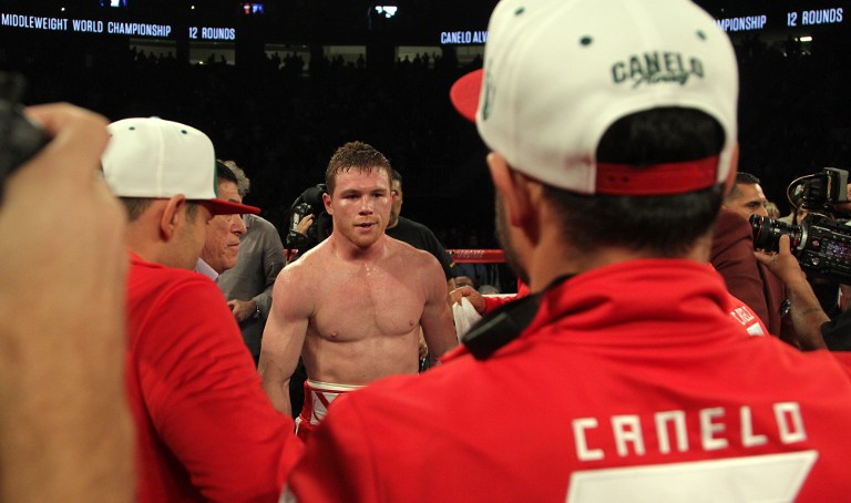 Saul Canelo Alvarez (C) of Mexico is surrounded by his corner after his sixth round knockout of Amir Khan of Great Britain (out of frame) following their WBC Middleweight Championship fight at the T-Mobile Arena, Saturday, May 7, 2016 in Las Vegas, Nevada. AFP File photo