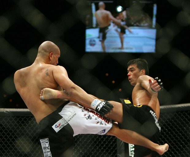 (FILES) This file photo taken on February 4, 2007 shows Brazilian Lyoto Machida (R) fighting with Sam "The Alaskan Assassin" Hoger of the US during their UFC 67: All or Nothing fight at the Mandalay Bay Hotel in Las Vegas, Nevada. In the space of 15 years, two brothers from Las Vegas have transformed UFC from a little known, somewhat frowned upon brand into the dominant company in mixed martial arts. / AFP PHOTO / GABRIEL BOUYS