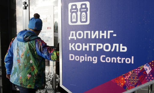 FILE - In this Feb. 21, 2014, file photo, a man walks past a sign reading doping control, at the Laura biathlon and cross-country ski center, at the 2014 Winter Olympics in Krasnaya Polyana, Russia. The IOC "would not hesitate" to retest drug samples from the 2014 Winter Games in Sochi if there is evidence that doping controls were manipulated, according to the Olympic body's medical director. A Russian whistleblower told CBS' "60 Minutes" that four Russian gold medalists from the Sochi Olympics used steroids and Russian security agents worked as doping control officers during the games. (AP Photo/Lee Jin-man, File)