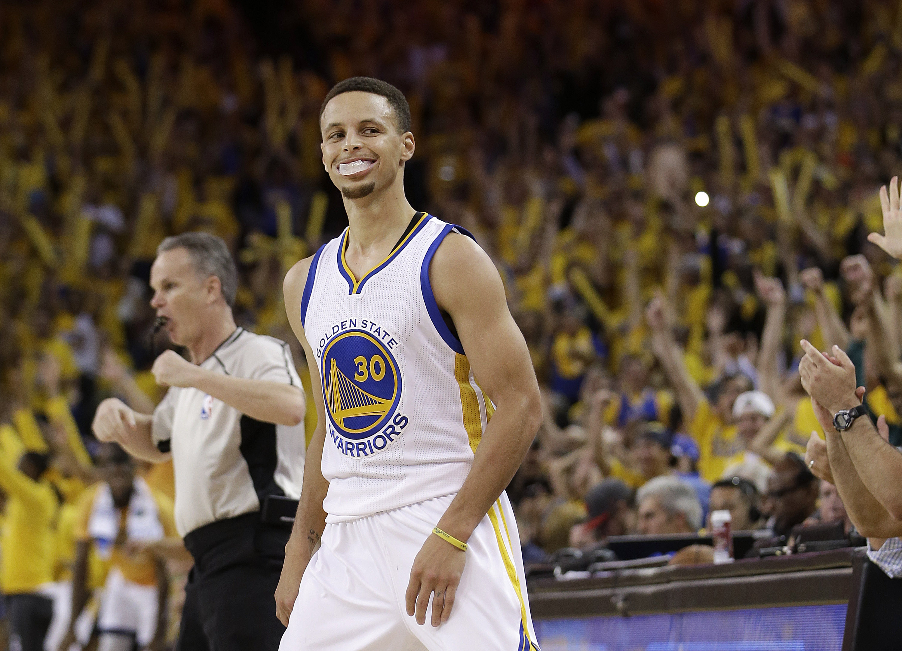 Golden State Warriors guard Stephen Curry (30) smiles after scoring against the Oklahoma City Thunder during the second half of Game 2 of the NBA basketball Western Conference finals in Oakland, Calif., Wednesday, May 18, 2016. AP