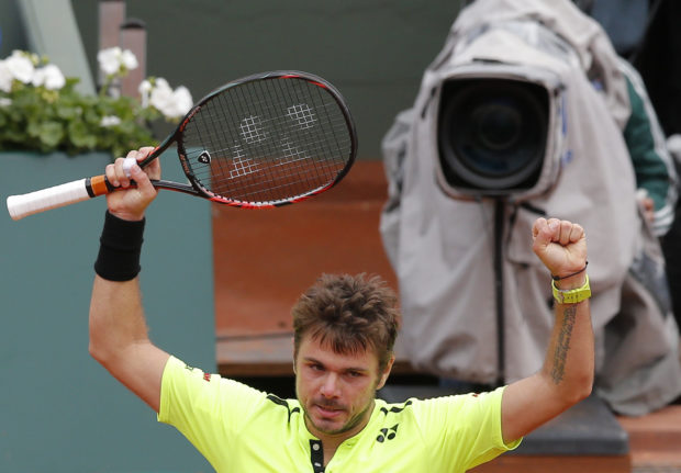 Defending champion Switzerland's Stan Wawrinka celebrates after defeating Czech Republic's Lukas Rosol during their first round match of the French Open tennis tournament at the Roland Garros stadium, Monday, May 23, 2016 in Paris.  (AP Photo/Christophe Ena)