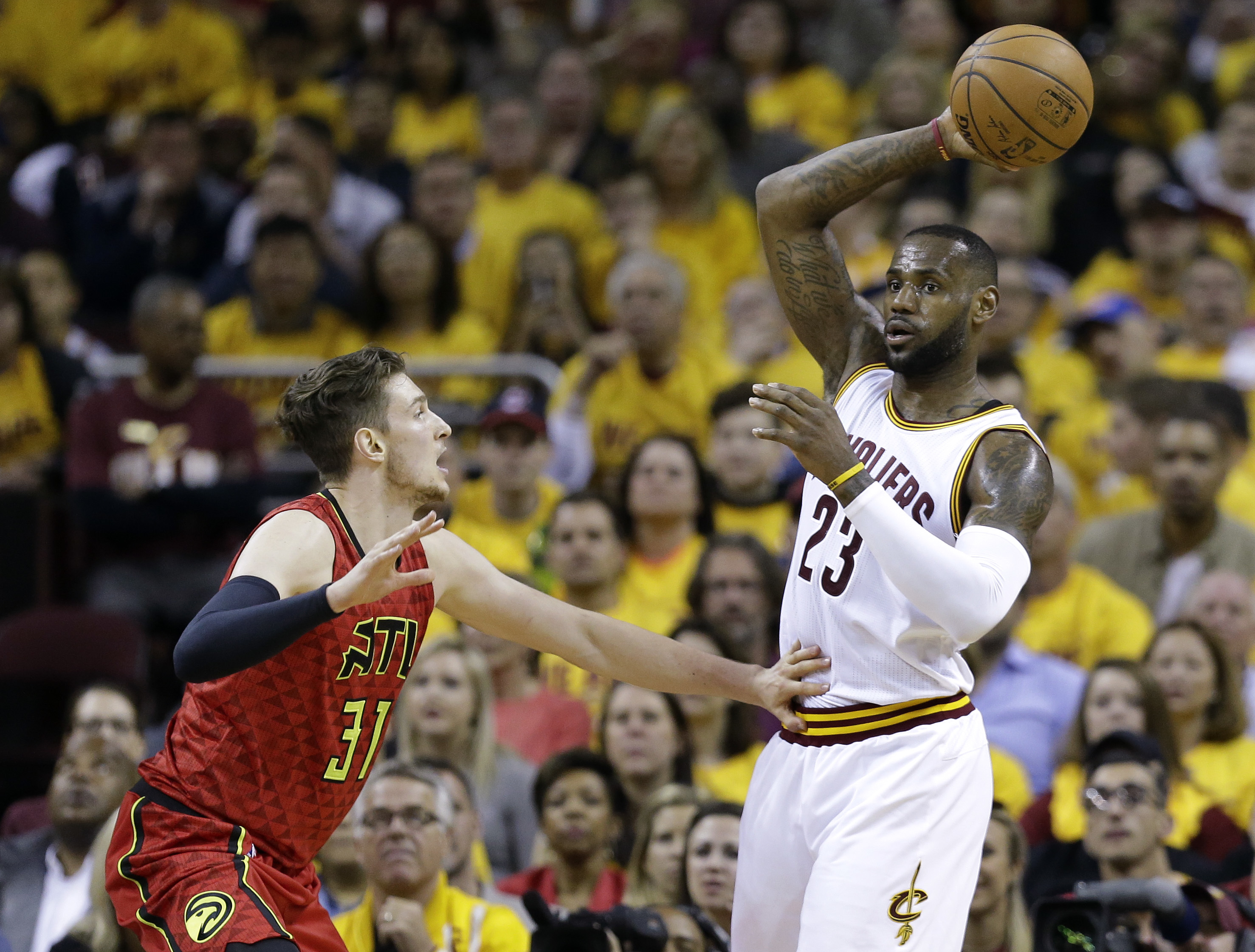 Cleveland Cavaliers forward LeBron James (23) looks for an open teammate against Atlanta Hawks forward Mike Muscala (31) in the first half during Game 2 of a second-round NBA basketball playoff series, Wednesday, May 4, 2016, in Cleveland. AP