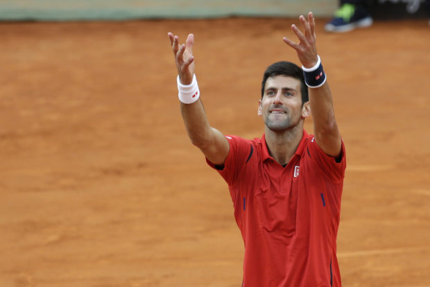 Novak Djokovic, of Serbia, celebrates after beating Rafael Nadal, of Spain, in a quarter final match at the Italian Open tennis tournament, in Rome, Friday, May 13, 2016. Djokovic won 7-5, 7-6. (AP Photo/Alessandra Tarantino)