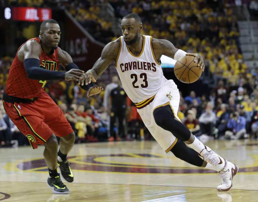 Cleveland Cavaliers' LeBron James (23) drives on Atlanta Hawks' Paul Millsap (4) in the second half in Game 1 of a second-round NBA basketball playoff series, Monday, May 2, 2016, in Cleveland. (AP Photo/Tony Dejak)