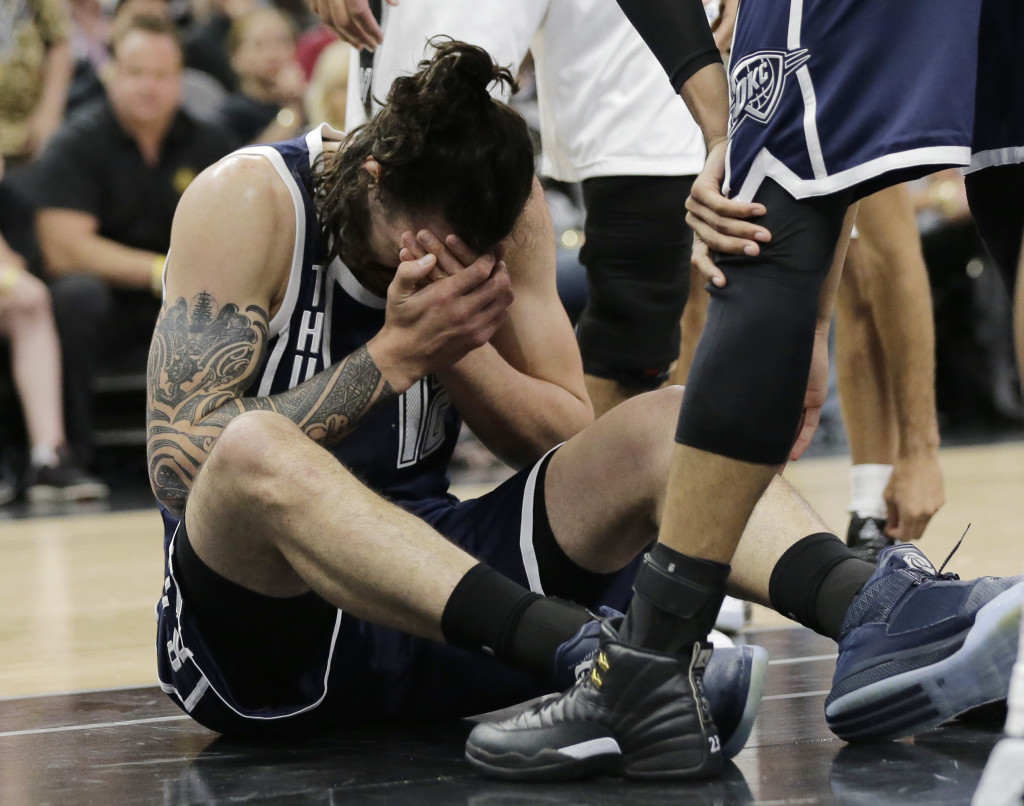 Oklahoma City Thunder center Steven Adams (12) holds his face after he was fouled during the first half in Game 1 of a second-round NBA basketball playoff series against the San Antonio Spurs, Saturday, April 30, 2016, in San Antonio. (AP Photo/Eric Gay)