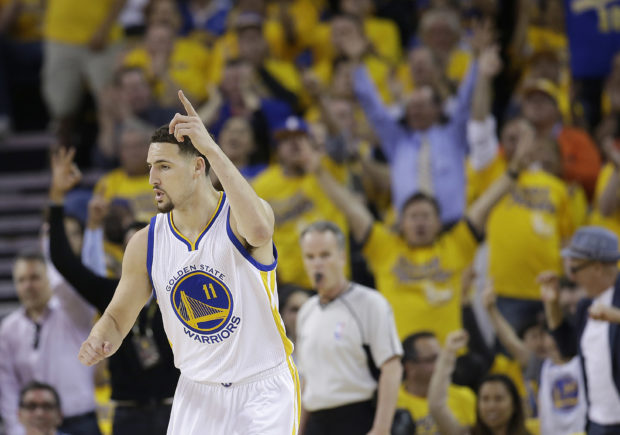 Golden State Warriors guard Klay Thompson (11) reacts after scoring against the Oklahoma City Thunder during the first half of Game 2 of the NBA basketball Western Conference finals in Oakland, Calif., Wednesday, May 18, 2016. (AP Photo/Marcio Jose Sanchez)