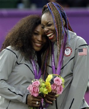 In this file photo, taken on Aug. 5, 2012, at the London Summer Olympics, Serena Williams, left, and Venus Williams of the United States celebrate on podium after receiving their gold medals in women's doubles. The winningest team in Olympic tennis history has entered the doubles draw at this week's Italian Open to kick off their preparations for the Rio de Janeiro Games. AP