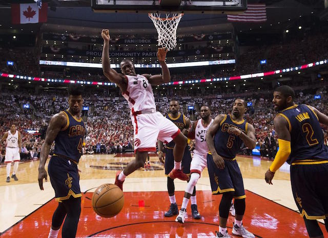 Toronto Raptors' Bismack Biyombo (8) dunks the ball past Cleveland Cavaliers guards Iman Shumpert (4) and J.R. Smith (5) during the first half of Game 3 of the NBA basketball Eastern Conference finals in Toronto on Saturday, May 21, 2016. Nathan Denette/The Canadian Press via AP