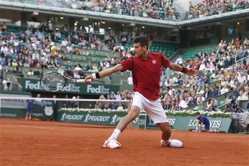 Novak Djokovic returns in the third round match of the French Open tennis tournament. AP