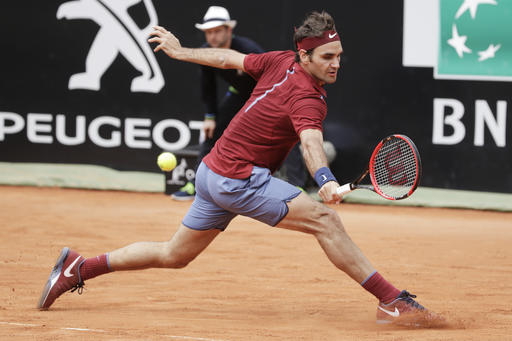 Roger Federer of Switzerland returns the ball to Dominic Thiem of Austria during their match at the Italian Open tennis tournament, in Rome, Thursday, May 12, 2016. AP