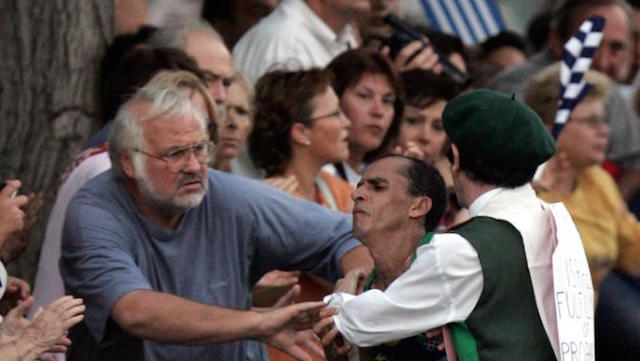 FILE - This Aug 29, 2004 file photo shows defrocked Irish priest Cornelius Horan, right, grabbing Vanderlei de Lima, of Brazil, and knocking him into the crowd during the men's Marathon event at the 2004 Olympic Games in Athens. The Olympics may be the most important event many swimmers, runners, weightlifters and the like will ever compete in, but that doesn't make them perfect. As the ongoing stories out of Brazil about Zika and poor water quality have shown, elaborate planning for the most grandiose of sporting events does not guarantee everything will run "as expected." AP