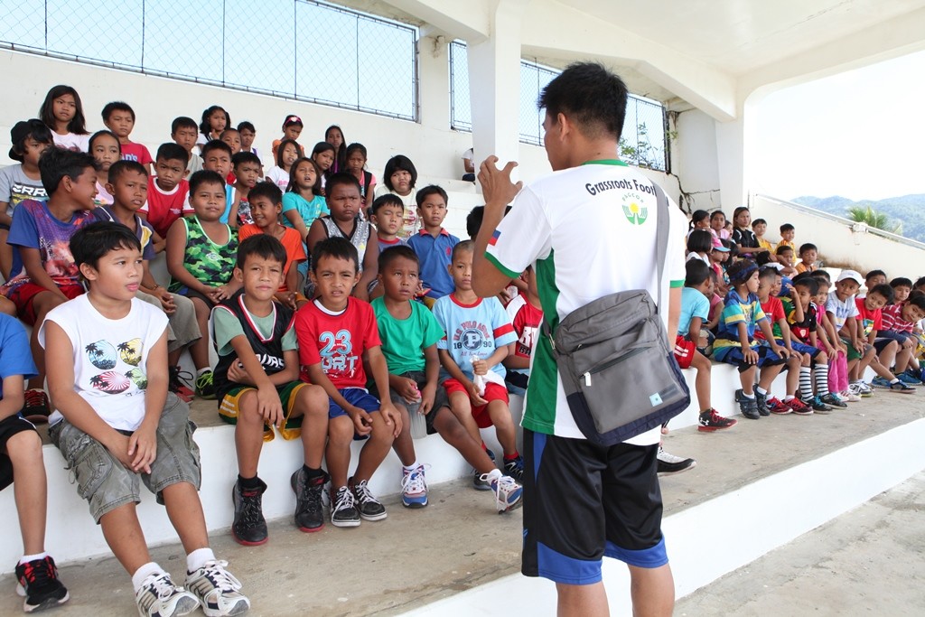 A football coach explains the rudiments of the sport to young participants during a football festival held recently in Catanduanes. PAGCOR