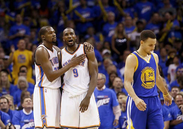 Oklahoma City Thunder forward Kevin Durant (35) and forward Serge Ibaka (9) embrace as Golden State Warriors guard Stephen Curry (30) walks away during the second half in Game 3 of the NBA basketball Western Conference finals  in Oklahoma City, Sunday, May 22, 2016. AP