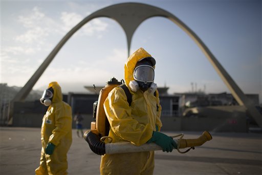 In this file photo, a health worker stands in the Sambadrome spraying insecticide to combat the Aedes aegypti mosquito that transmits the Zika virus in Rio de Janeiro, Brazil. The Sambadrome will be used for the Archery competition during the 2016 summer games. With the opening ceremony less than three months away, a Canadian professor has called for the Rio Olympics to be postponed or moved because of the Zika outbreak, warning the influx of visitors to Brazil will result in the avoidable birth of malformed babies. AP
