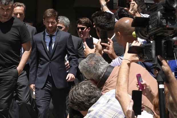 Barcelona's football star Lionel Messi (2ndL) leaves the courthouse on June 2, 2016 in Barcelona. The 28-year-old football star was cheered and jeered as he emerged from a van accompanied by his father Jorge Horacio Messi. The two are accused of using a chain of fake companies in Belize and Uruguay to avoid paying taxes on 4.16 million euros ($4.6 million) of Messi's income earned through the sale of his image rights from 2007-09. / AFP PHOTO / LLUIS GENE