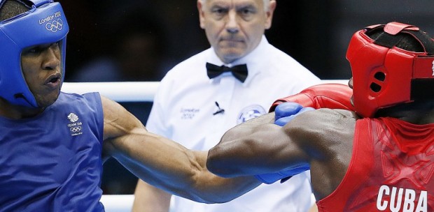 A Super-heavyweight (91+kg) boxing match in the  London 2012 Olympics at the ExCel Arena  August 1, 2012 in London. In a major upset, Joshua defeated Savon Cotilla with a 17-16 points decision.   AFP PHOTO / Jack GUEZ / AFP PHOTO / JACK GUEZ