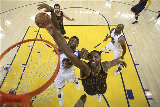 Golden State Warriors center Festus Ezeli (31) defends a shot by Cleveland Cavaliers center Tristan Thompson (13) during the second half of Game 2 of basketball's NBA Finals in Oakland, Calif., Thursday, June 2, 2016. The Warriors won 104-89. AP