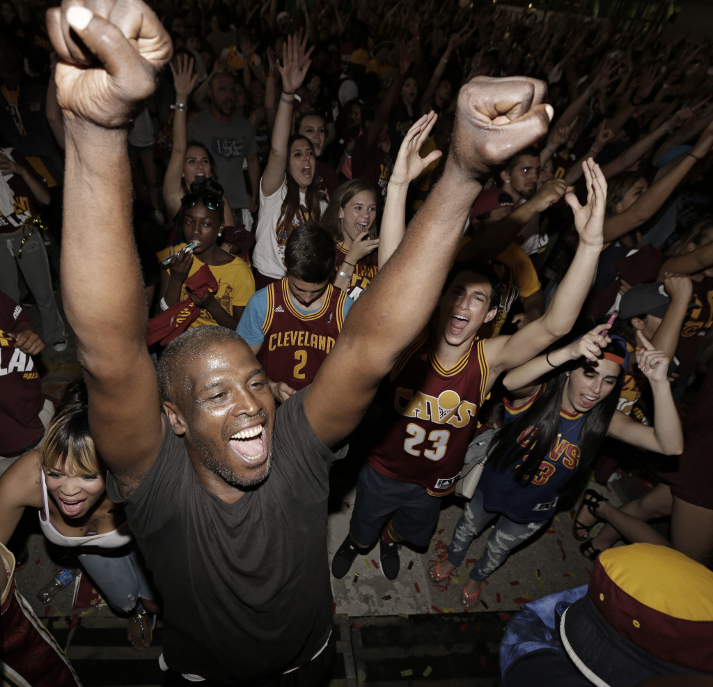 Cleveland Cavaliers fans celebrate after the Cavaliers defeated the Golden State Warriors 93-89 in Game 7 of the NBA basketball Finals, Sunday, June 19, 2016, in Cleveland. (AP Photo/Tony Dejak)