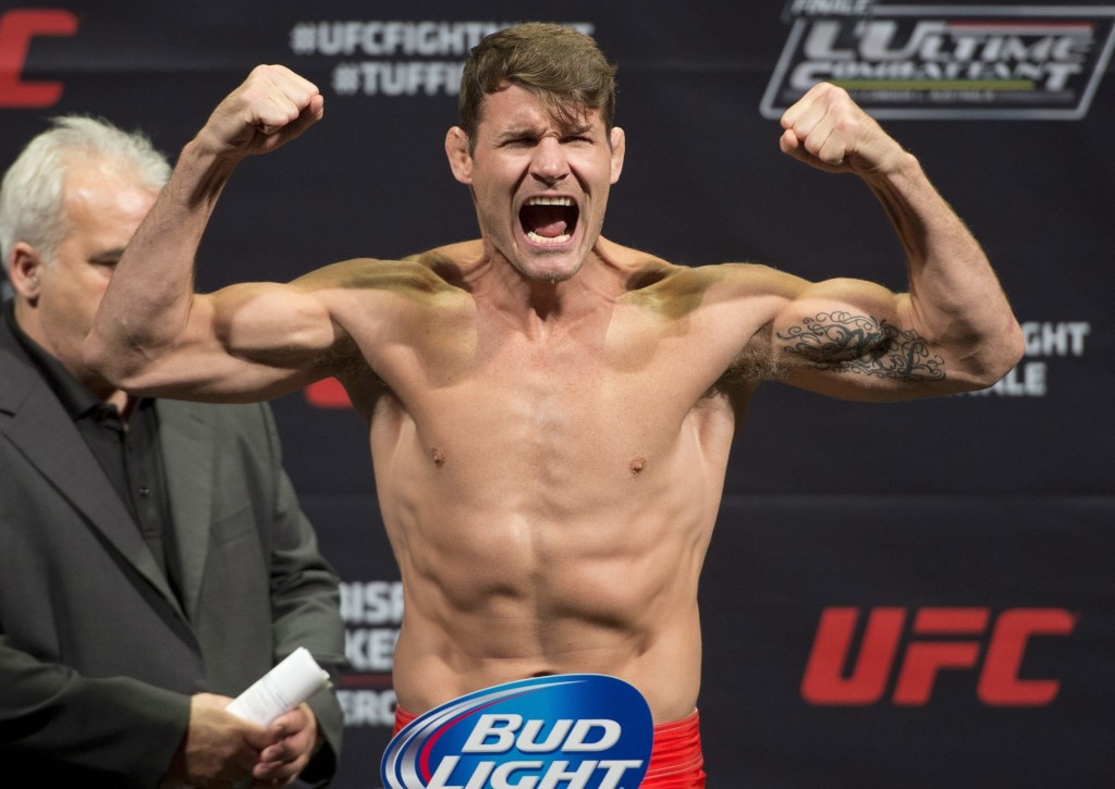 FILE - In this April 15, 2014, file photo, middleweight Michael Bisping, of England, gestures during the weigh-in for a fight against Tim Kennedy, of the United States, in Quebec City, Canada. Bisping has fashioned a profitable UFC career as a flamboyant English bad boy, yet he had never been given a title fight after 25 trips to the octagon. Thanks to Chris Weidman's late injury, the 37-year-old Bisping finally gets his long-awaited shot at middleweight champion Luke Rockhold's belt at UFC 199 on Saturday, June 4, 2016. (AP Photo/The Canadian Press, Jacques Boissinot, File) MANDATORY CREDIT