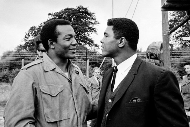 Heavyweight boxer Muhammad Ali, right, visits Cleveland Browns running back and actor Jim Brown on the film set of movie "The Dirty Dozen" at Morkyate, Bedfordshire, England, on Aug. 5, 1966.  AP