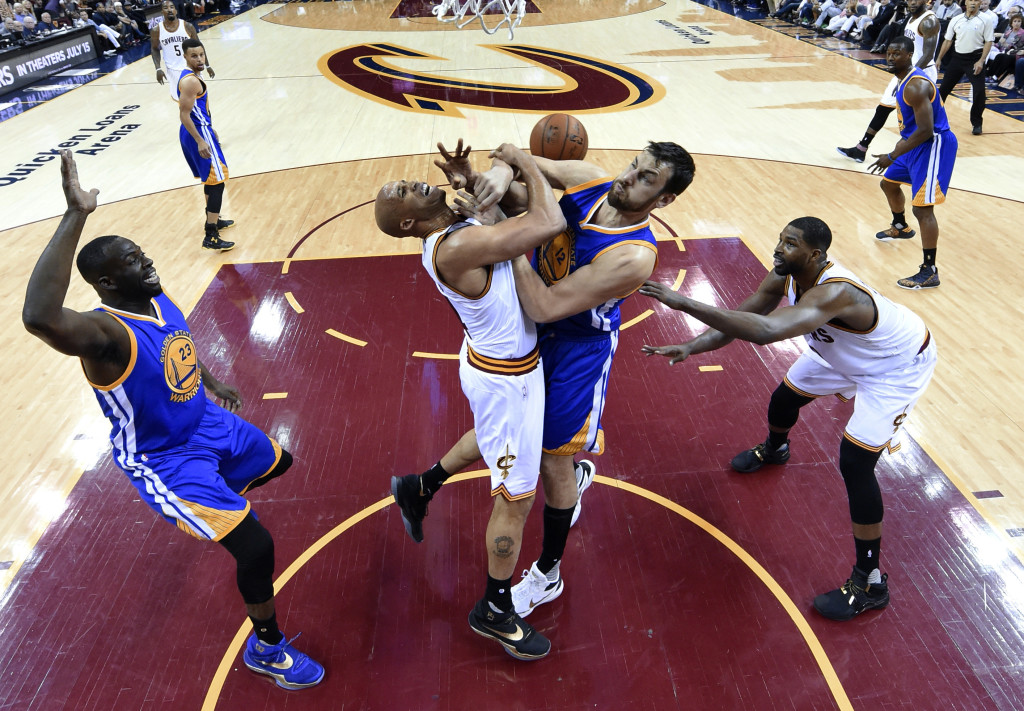 Cleveland Cavaliers forward Richard Jefferson, center left, and Golden State Warriors center Andrew Bogut compete for the ball during the second half of Game 4 of basketball's NBA Finals in Cleveland, Friday, June 10, 2016. Golden State won 108-97. (Bob Donnan/Pool Photo via AP)