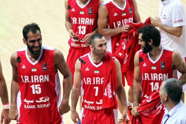 Hamed Haddadi, left, Mehdi Kamrani, middle, and Nikkhah Bahrami share a laugh while heading back to the bench. Fiba.com
