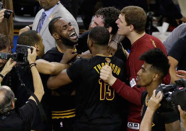 Cleveland Cavaliers forward LeBron James, top left, celebrates with teammates after Game 7 of basketball's NBA Finals against the Golden State Warriors in Oakland, Calif., Sunday, June 19, 2016. The Cavaliers won 93-89. AP