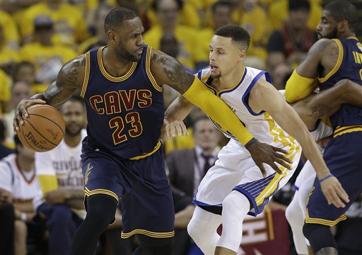 Cleveland Cavaliers forward LeBron James (23) dribbles against Golden State Warriors guard Stephen Curry during the first half of Game 1 of basketball's NBA Finals in Oakland, Calif., Thursday, June 2, 2016. AP