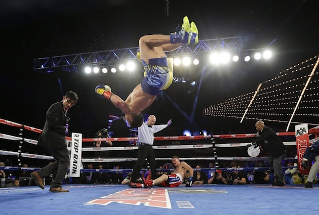 Vasyl Lomachenko, of Ukraine, does a back flip as he celebrates after knocking out Roman Martinez, of Puerto Rico, during the fifth round  of a WBO junior lightweight title boxing match Saturday, June 11, 2016, in New York. Lomachenko stopped Martinez in the fifth round. AP