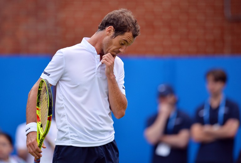 France's Richard Gasquet reacts after losing the first set in his men's singles match against US player Steve Johnson at the ATP tournament at Queen's tennis club, in London in west London on June 13, 2016. / AFP PHOTO / GLYN KIRK