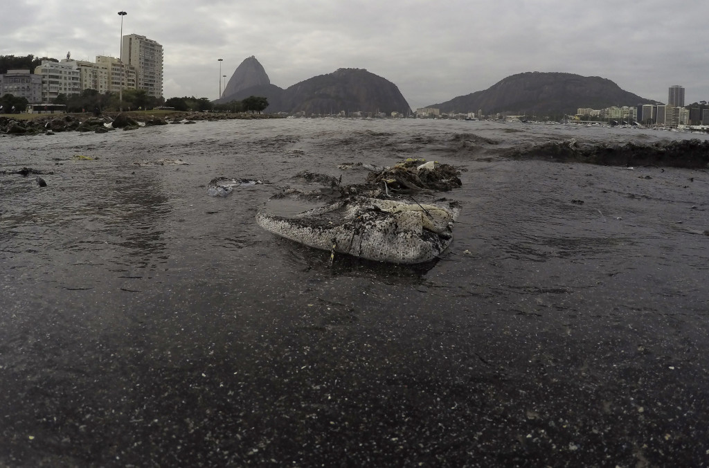 Thrash floats on the water of Botafogo beach next to the Sugar Loaf mountain and the Guanabara Bay where sailing athletes will compete during the 2016 Summer Olympics in Rio de Janeiro, Brazil, Saturday, July 30, 2016. A recent investigation by Associated Press on water quality at aquatic venues for the 2016 Olympic Games in Rio de Janeiro, Brazil, has raised concerns about the risk to the health of athletes who will compete. The games start on August 5.(AP Photo/Leo Correa)