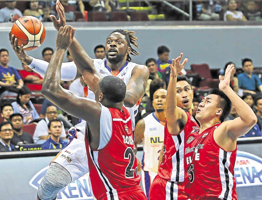 NLEX import Henry Walker takes it strong to the basket off Blackwater reinforcement Eric Dawson and Riego Gamalinda in yesterday’s game at Mall of Asia Arena in Pasay. KIMBERLY DELA CRUZ