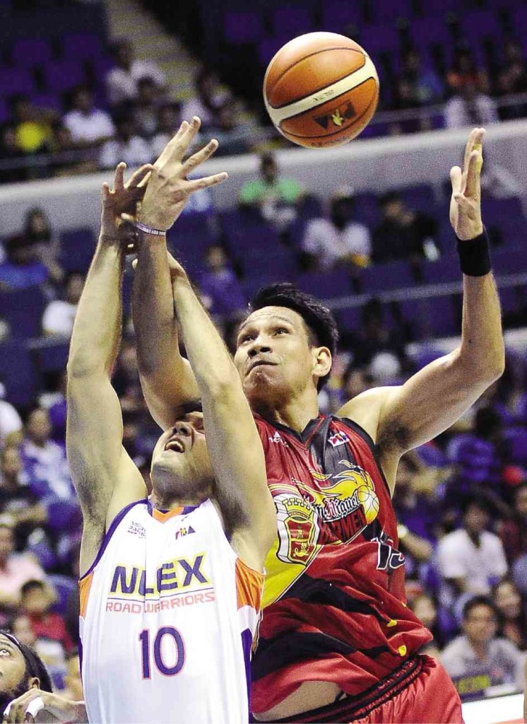 SAN MIGUEL BEER center June Mar Fajardo (right) goes over the back of NLEX’s Sean Anthony for a rebound. AUGUST DELA CRUZ