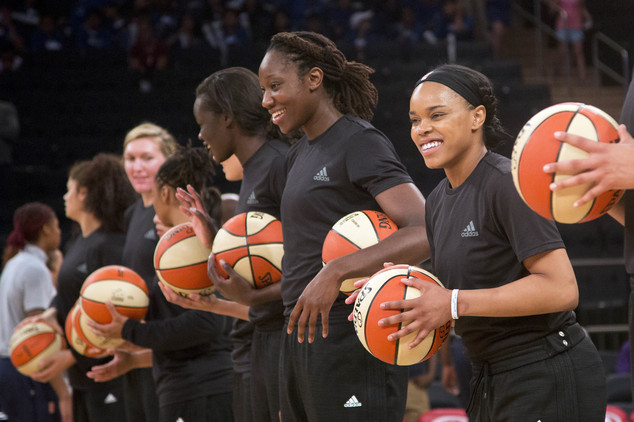 FILE - In this Wednesday, July 13, 2016 file photo, members of the New York Liberty basketball team await the start of a game against the Atlanta Dream in New York. The WNBA is withdrawing its fines for teams and players that showed support of citizens and police involved in recent shootings by wearing black warmup shirts before and during games. WNBA President Lisa Borders said in a statement Saturday, July 23, the league was rescinding penalties given to the Indiana Fever, New York Liberty, Phoenix Mercury and their players for wearing the shirts–which was a uniform violation. The players started wearing them to show solidarity after shootings in Minnesota and Baton Rouge, La. AP