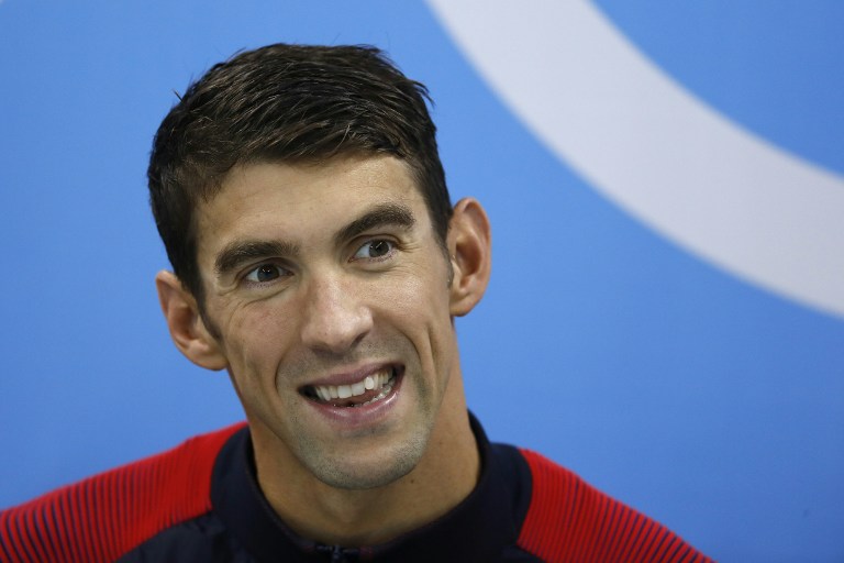 USA's Michael Phelps smiles during the podium ceremony of the Men's swimming 4 x 100m Medley Relay Final at the Rio 2016 Olympic Games at the Olympic Aquatics Stadium in Rio de Janeiro on August 13, 2016.   / AFP PHOTO / Odd Andersen